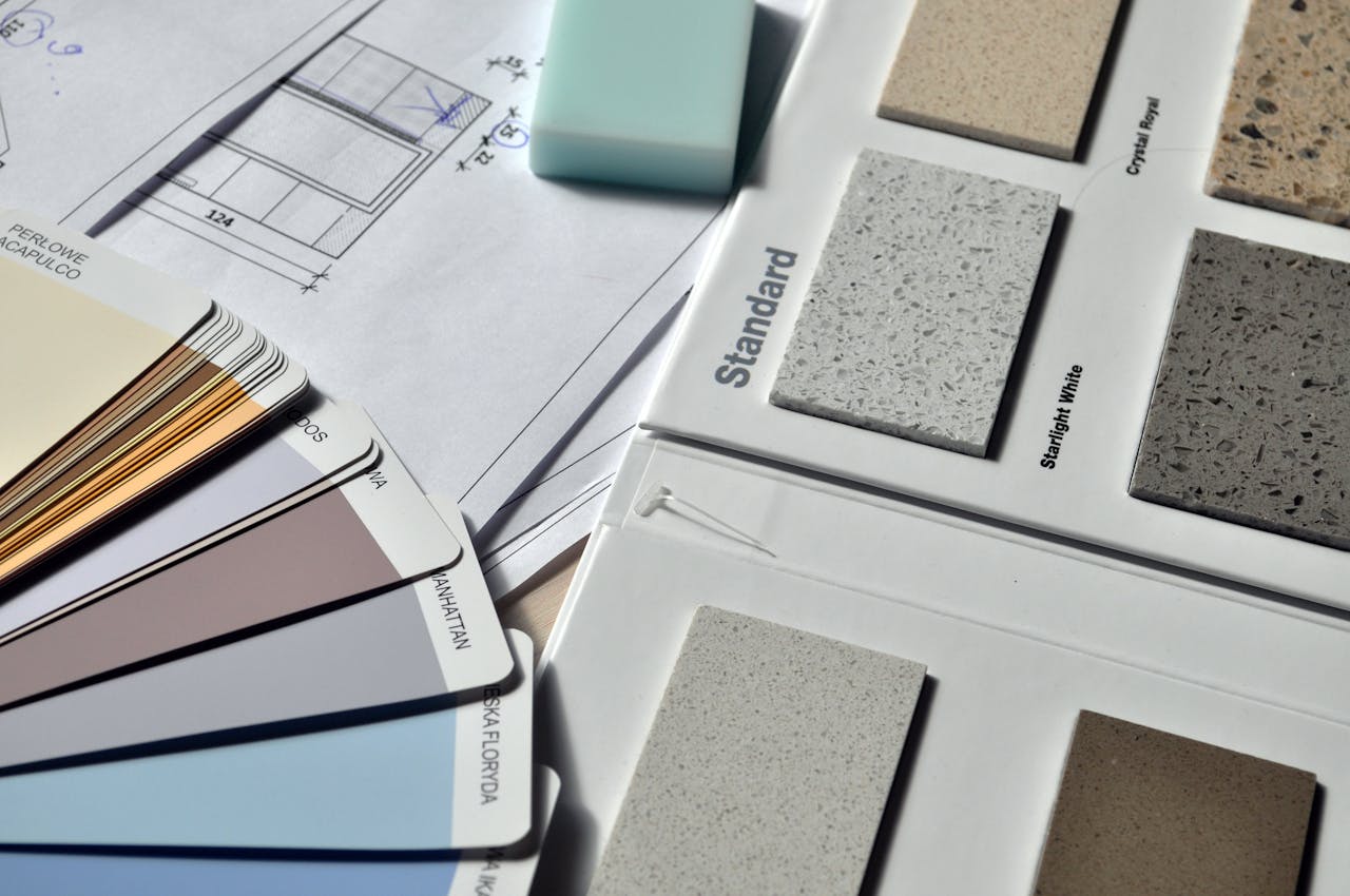home-hero Color palette and material samples for interior renovation projects on a blueprint.